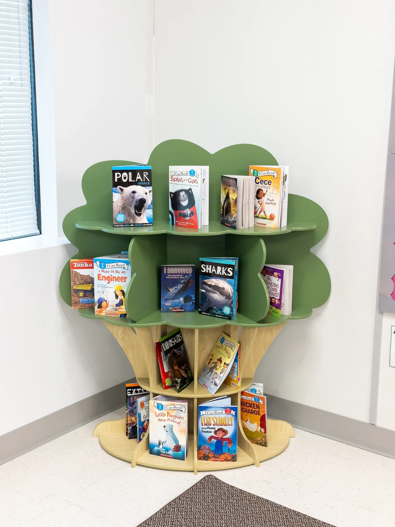 A tree-shaped bookshelf filled with picture books